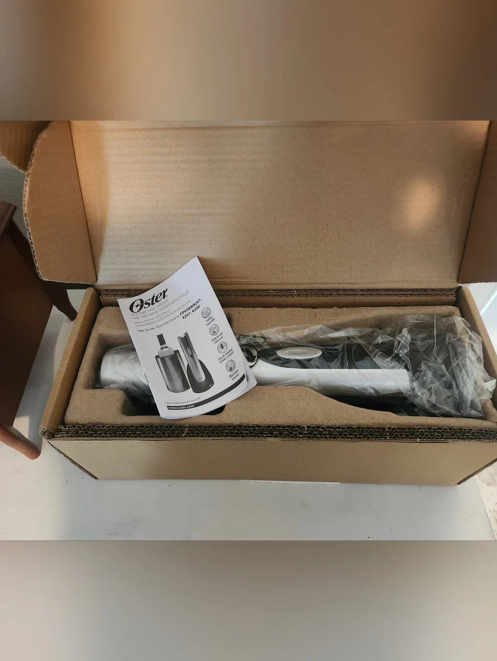 New In Box. Oster Silver and Black Electric Wine Opener with Charging Base.
